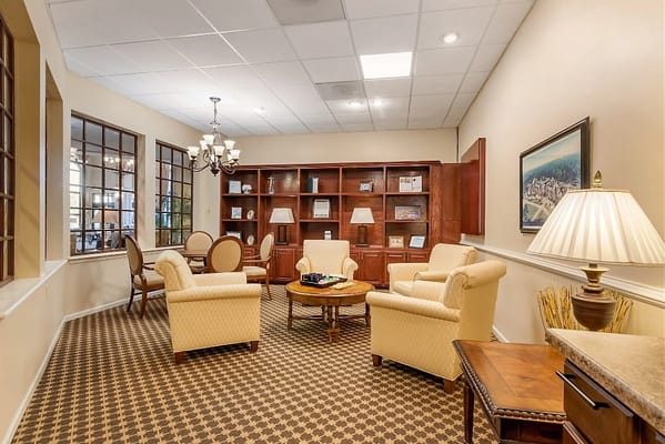 Comfortable common area with seating and bookshelf