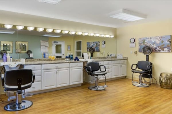 Hair salon area with styling chairs and mirrors