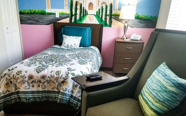 Cozy resident room with bed and chair