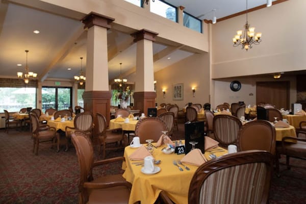 Bright dining room with set tables for meals