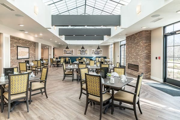 Modern dining room with large windows and tables
