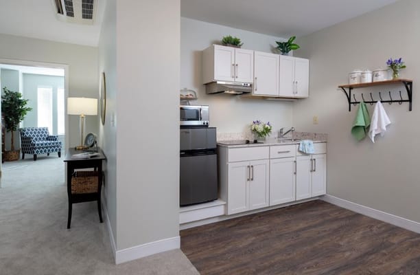 Compact kitchen area with appliances and decor