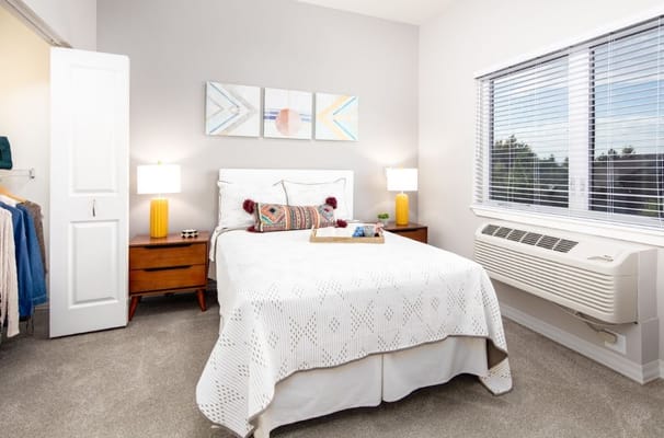 Bright and inviting bedroom with a bed, nightstand, and window
