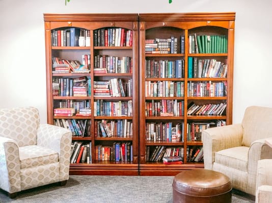 Cozy reading area with bookshelves and chairs