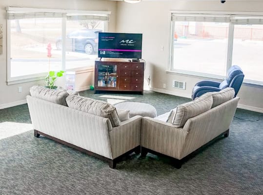Interior view of a common area with seating and TV