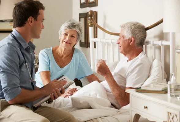 Caregiver interacting with elderly residents in their room