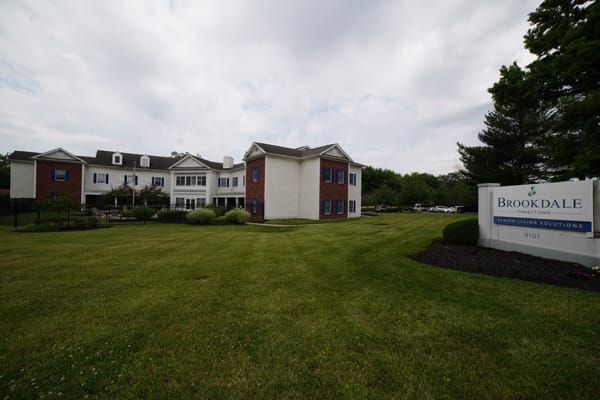 Exterior view of a senior living facility with signage