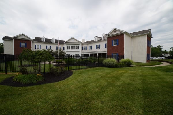 Exterior view of a senior living facility with landscaped grounds