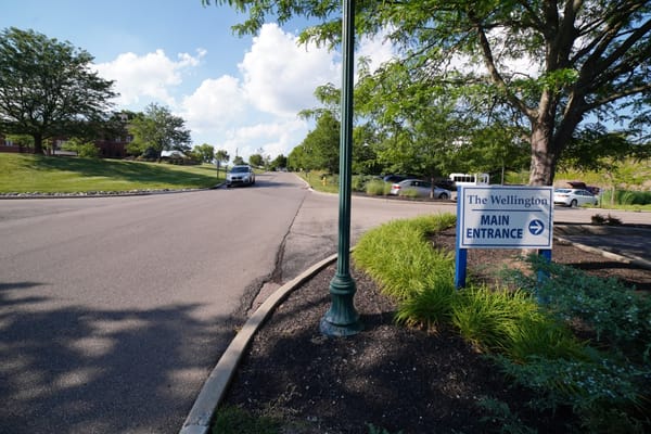 Entrance sign for The Wellington assisted living facility