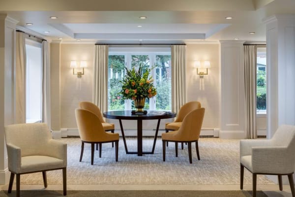 Common area with a table and chairs, floral arrangement