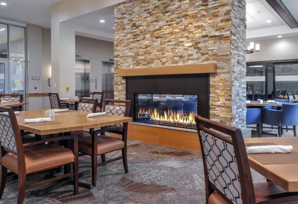 Dining room with a cozy fireplace and seating