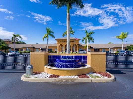 Fountain with palm trees at the entrance of Gardens of Venice.