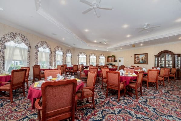 Elegant dining room with round tables and chairs set for a meal