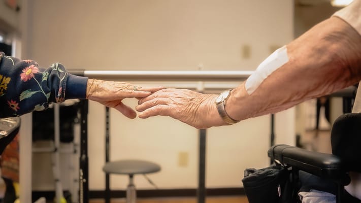 Close-up of two hands reaching towards each other