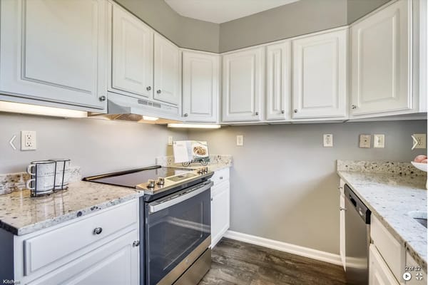 Bright kitchen with white cabinets and modern appliances