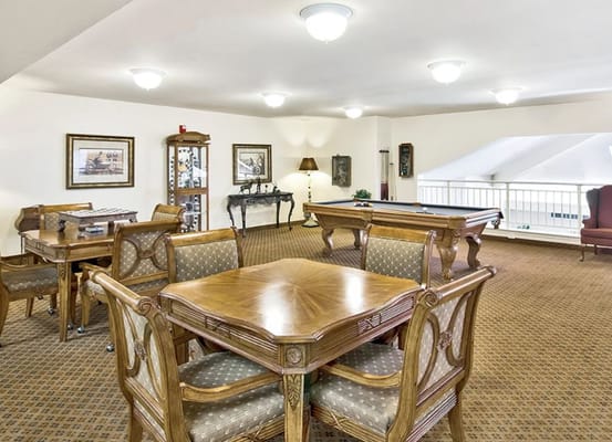 Cozy common area with wooden tables and a pool table
