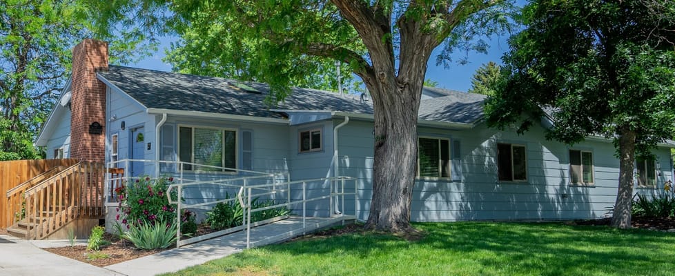 Exterior view of a senior care facility with landscaped lawn