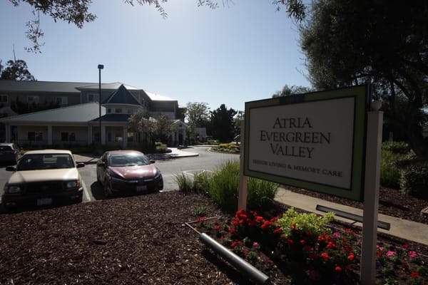 Exterior view of Atria Evergreen Valley with signage