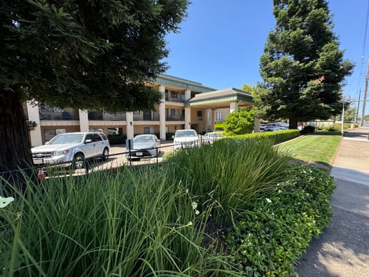Exterior view of a senior living facility with landscaping