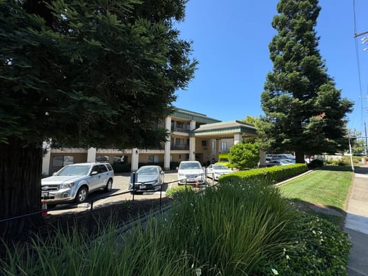 Exterior view of Atria Carmichael Oaks with landscaped area