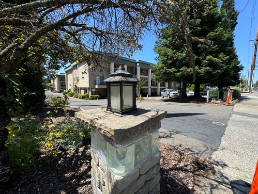 Exterior view of the facility building with landscaped entrance