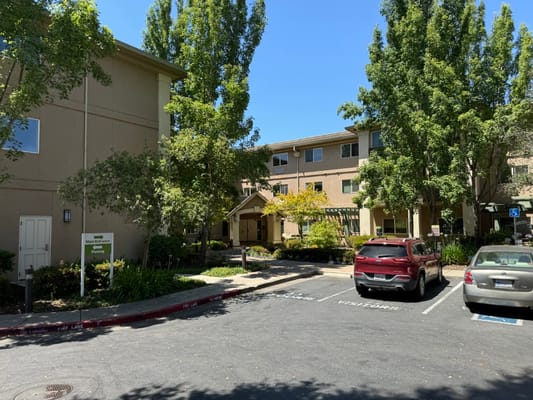Exterior view of Atria Carmichael Oaks with landscaping
