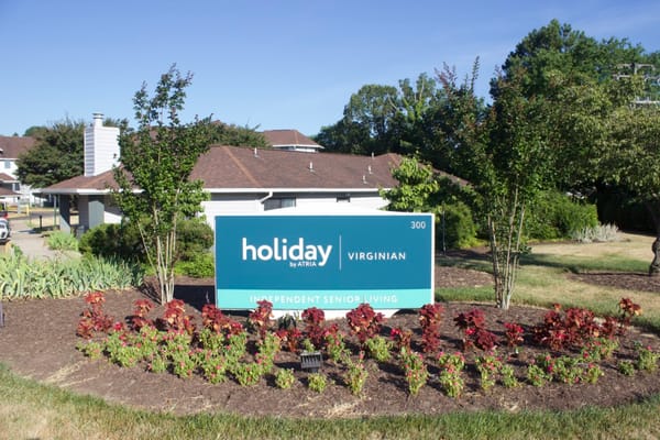 Exterior view of Holiday Virginian sign and landscaping