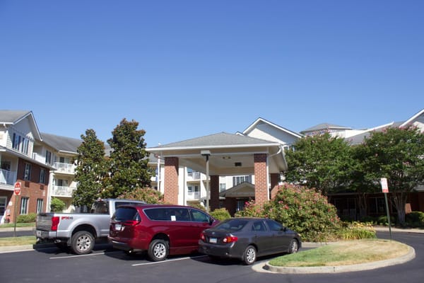 Exterior view of the Dogwood Terrace building with cars parked