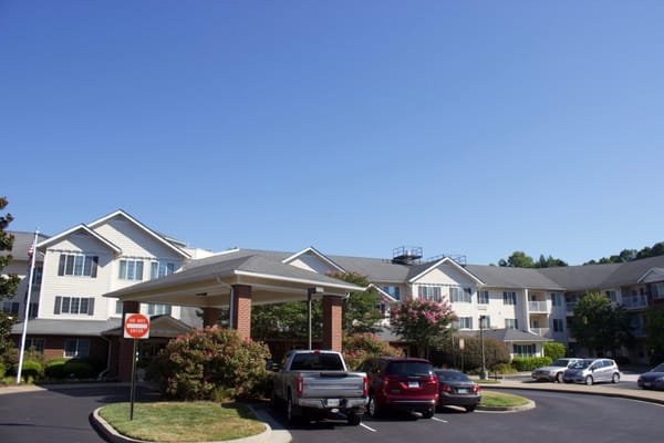 Exterior view of Dogwood Terrace with parking and flowers