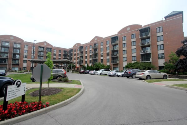 Exterior view of Marquette Senior Living building with parking