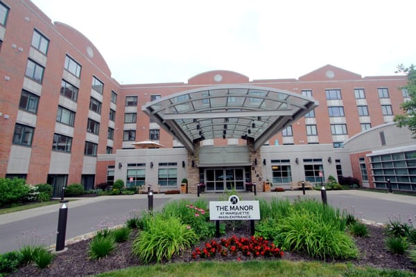 Main entrance of The Manor at Marquette with landscaping