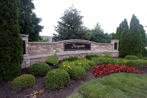 Signage of Marquette with decorative landscaping