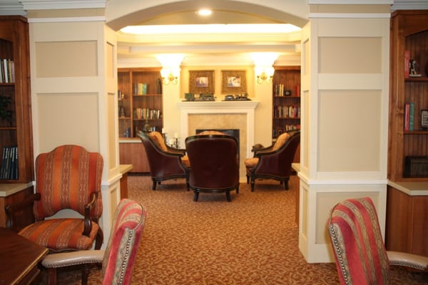 Cozy common area with chairs and bookshelves