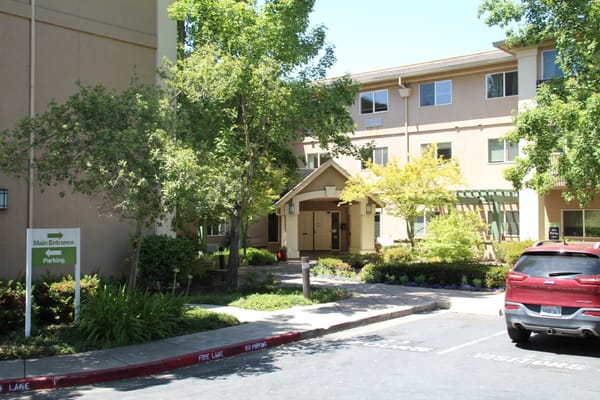 Main entrance of Atria Carmichael Oaks with parking area