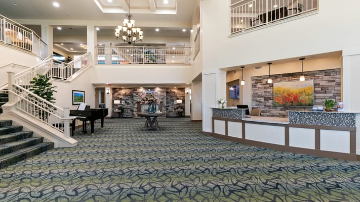 Spacious lobby of Ivy Park at Murrieta featuring a grand staircase and front desk.