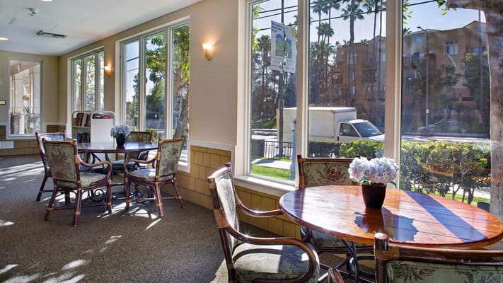Bright common area with large windows and tables