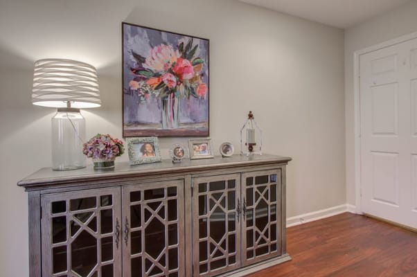 Decorative lobby console with flowers and photographs