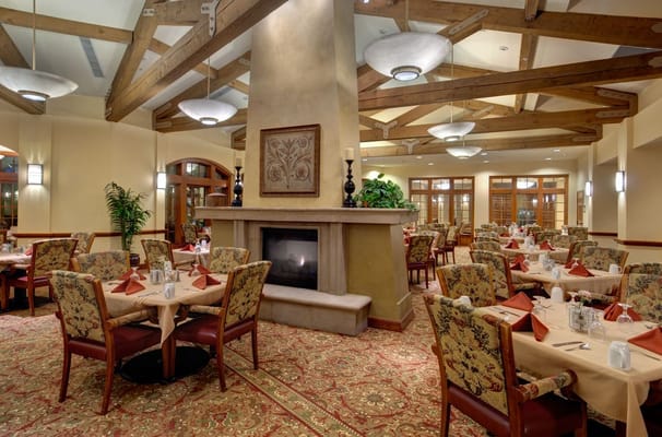 Cozy dining room with tables set for meals
