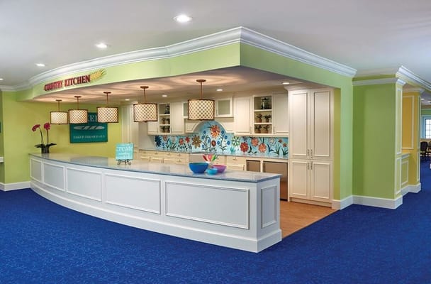 Brightly designed kitchen area with colorful decor and a curved counter.