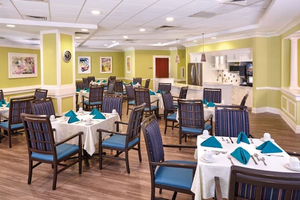 Brightly decorated dining room with tables set for meals