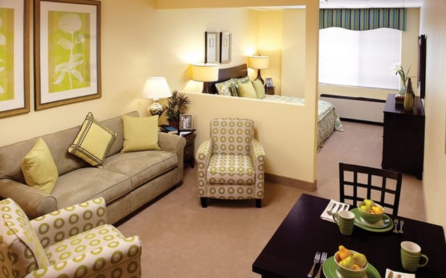 Living room area with a sofa, chairs, and dining table