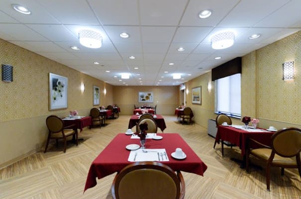 Dining area with red tablecloths and floral decorations