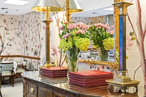 Well-decorated common area featuring flowers and decor