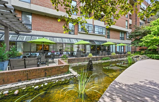 Outdoor patio area with seating and a water feature