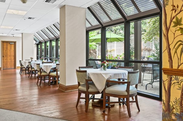 Bright dining area with outdoor views and tables