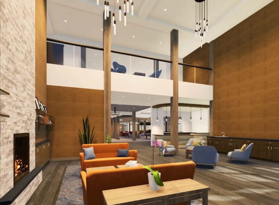 Spacious living room with modern decor and seating areas