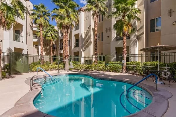Well-maintained pool area with palm trees