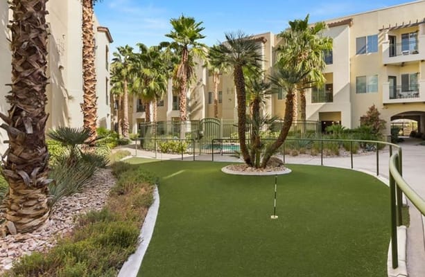 A beautifully landscaped outdoor space with palm trees and greenery