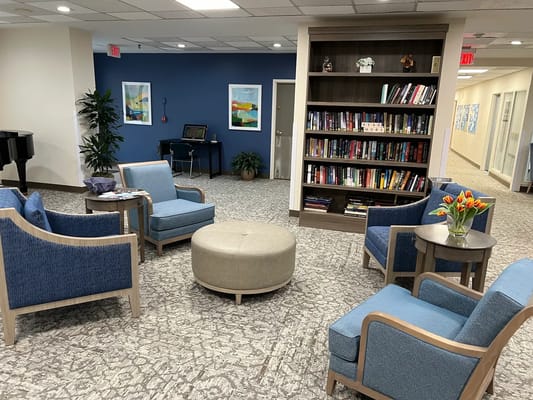 Cozy common area with seating and a bookshelf