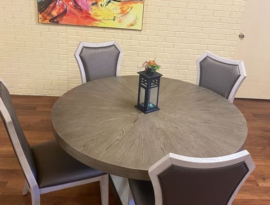 Interior dining setup with a round table and chairs